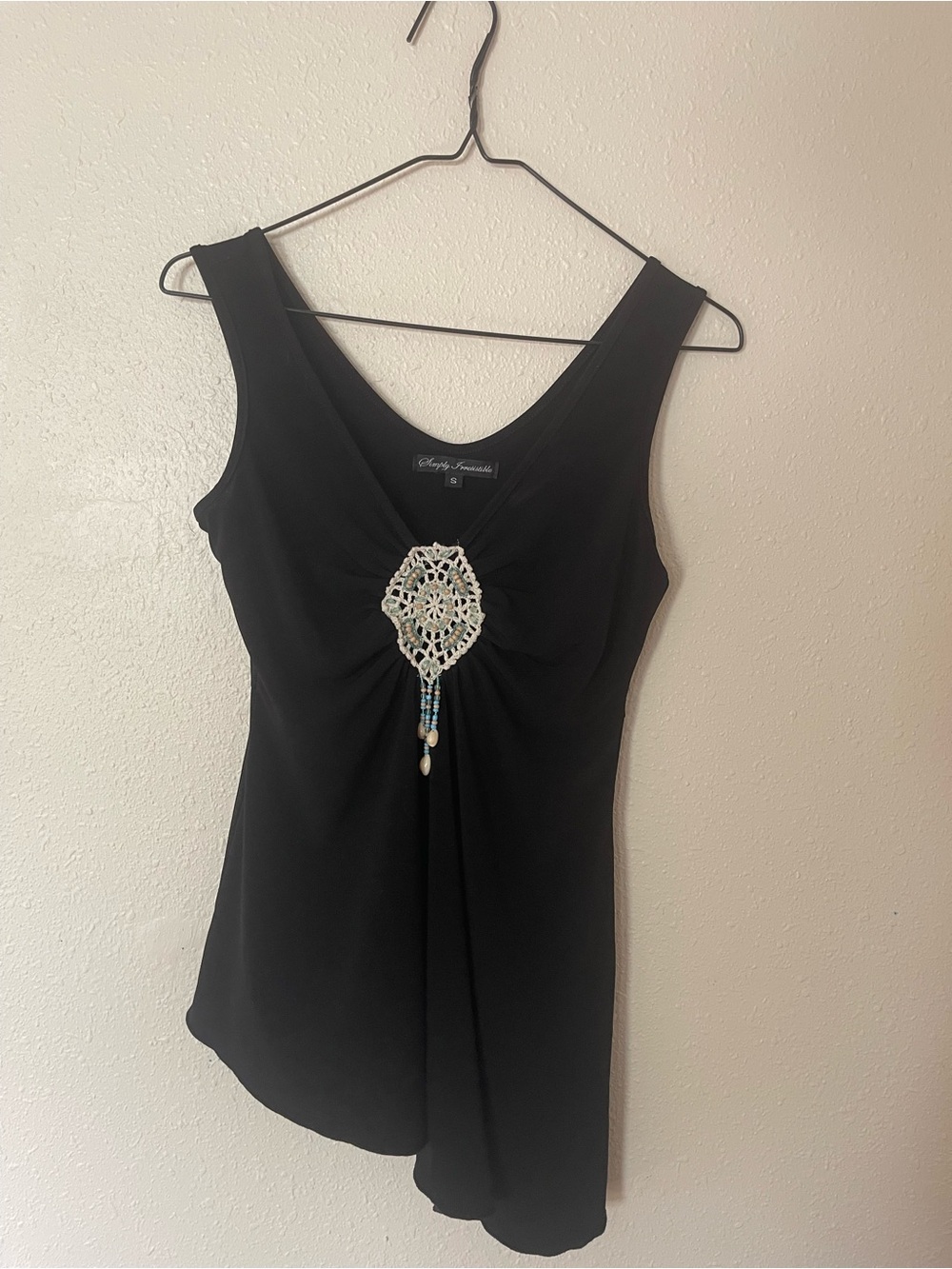 Black asymmetrical blouse with beaded pendant